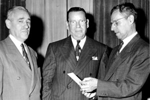 Board of Trustees Meeting, ca. 1949 L to R: Meyer Jaffe, Morris Shapiro, and unidentified gentleman who is looking at a document he is holding in his hands. 