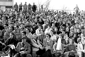 Homecoming Game ca. 1950. Black and white photograph shows a large crowd in the bleachers watching a game.