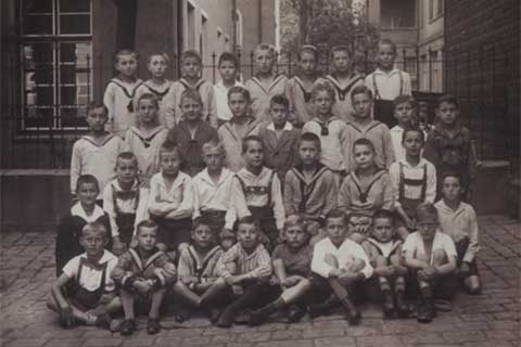 Black and white photo of a posed class of children