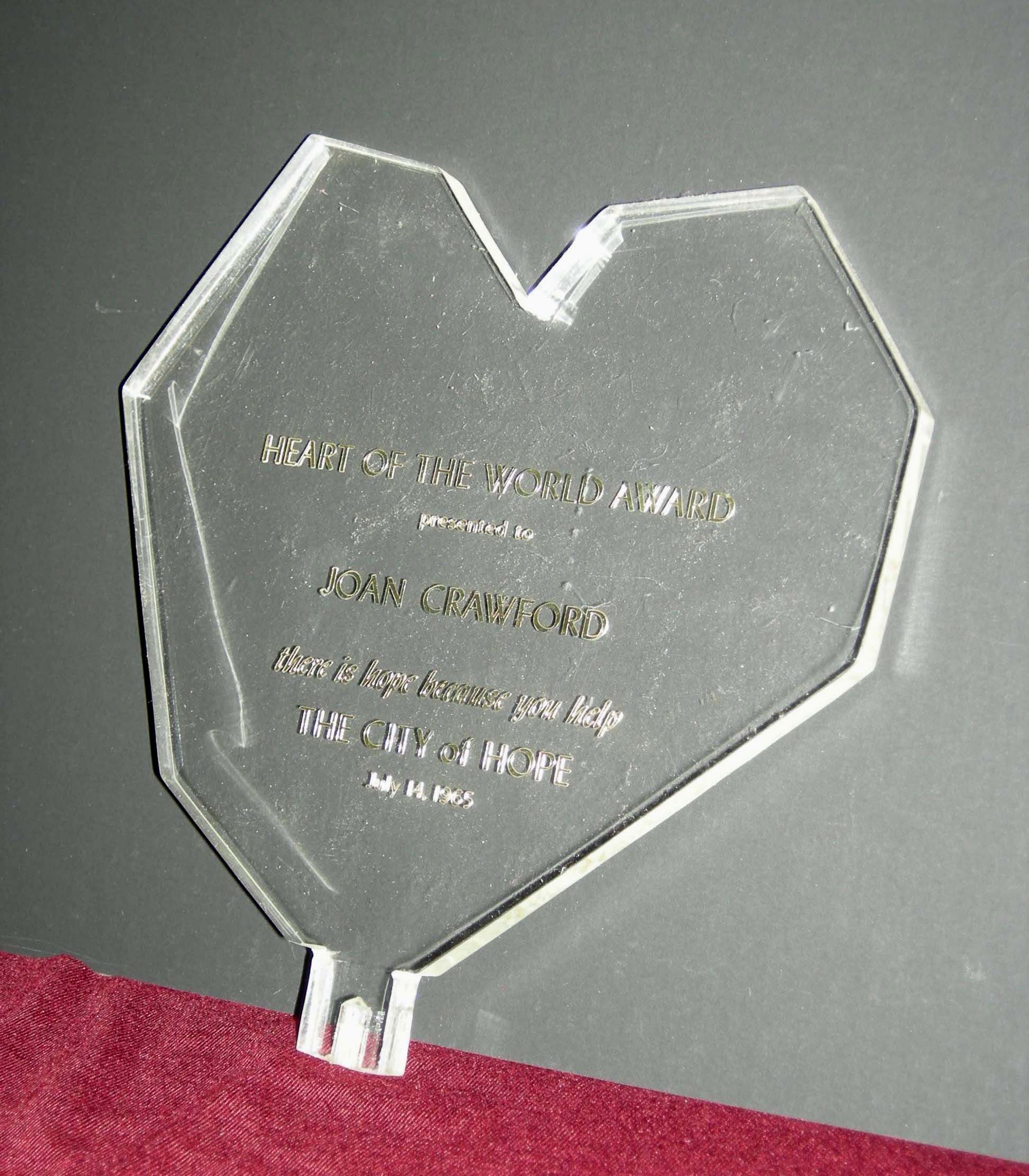 Clear, heart-shaped award plaque