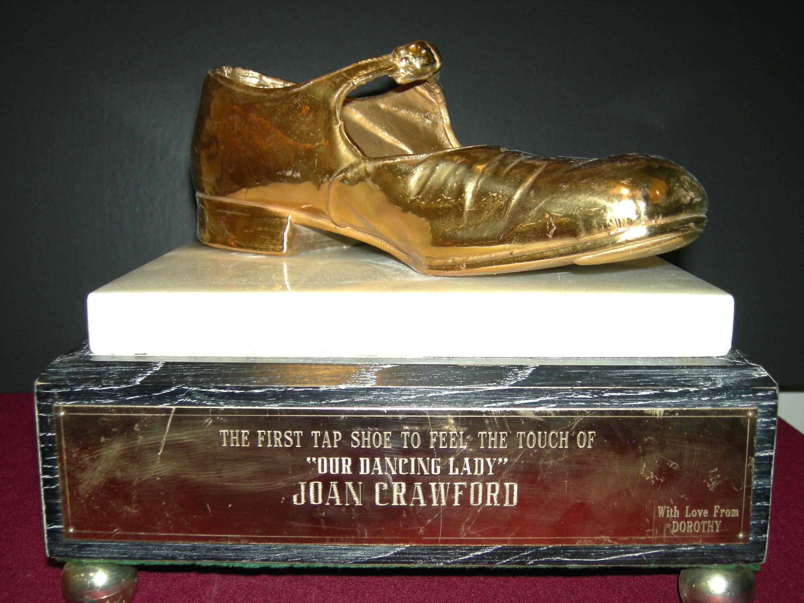 Award statue with gold shoe