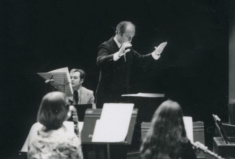 Man in suit with three musicians