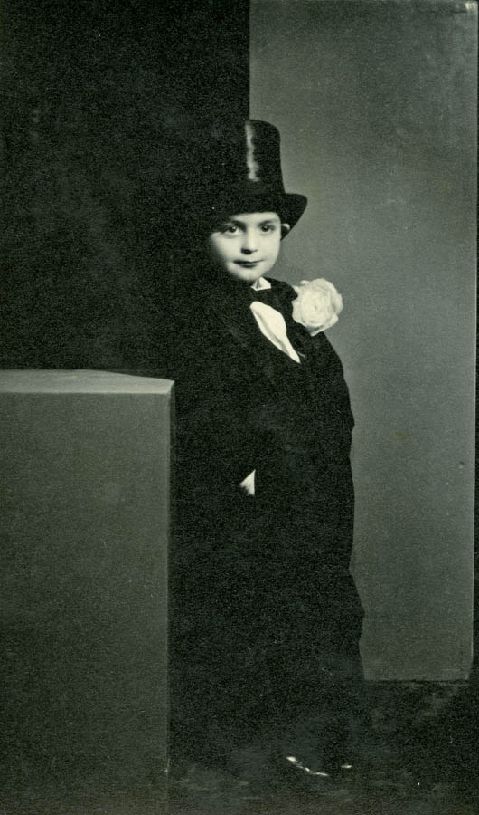 Boy about 5 years old standing in tuxedo and top hat