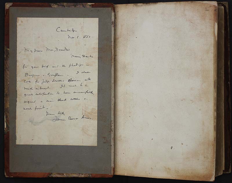 A handwritten note in the inside front cover of Louis D. Brandeis's Law book (color photograph). The note is dated March or Nov 5, 1883 from Cambridge from a man named James who presumably gifted Brandeis with the book.