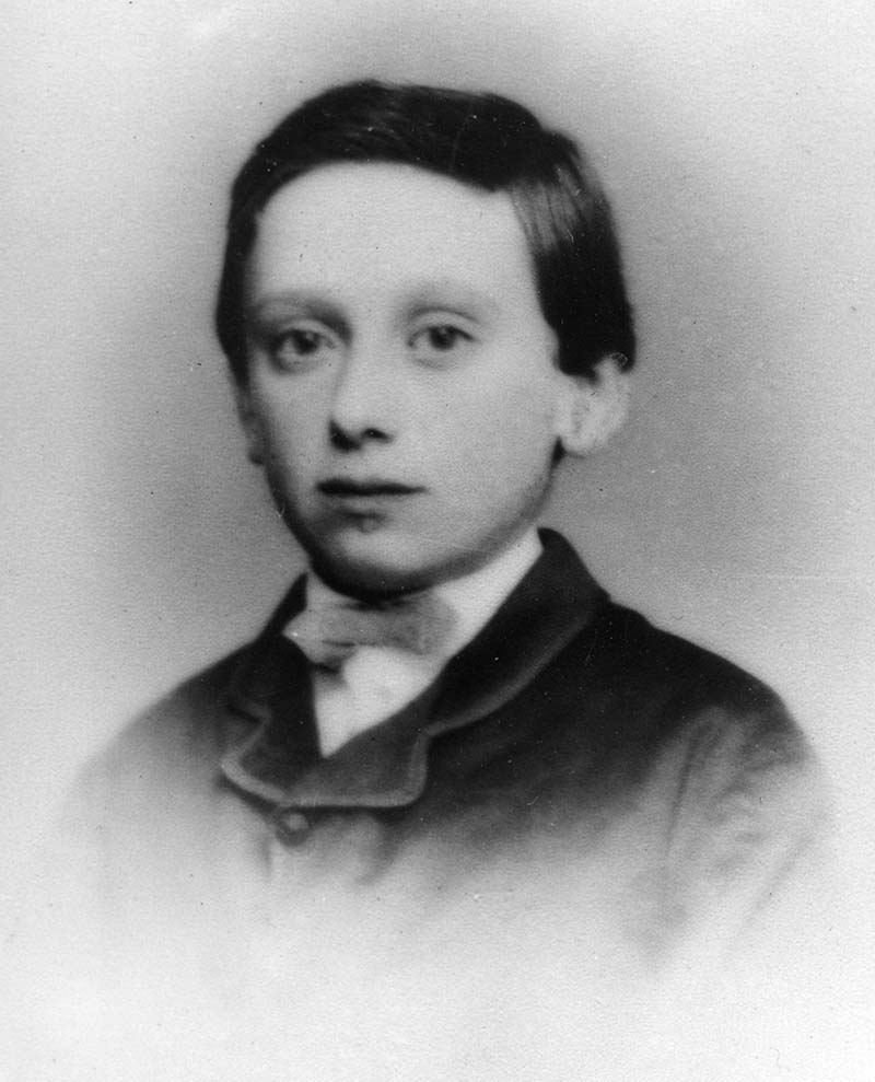 Louis Brandeis as a young boy looking into the camera, with his torso area washed out by lighting effects (black and white photograph, circa 1870.)