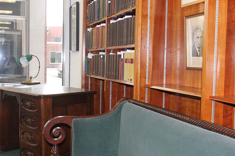 Bookcase, sofa, desk, framed portrait of Justice Brandeis