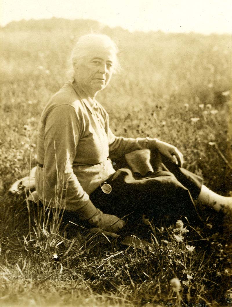 Alice G. Brandeis sitting in a field