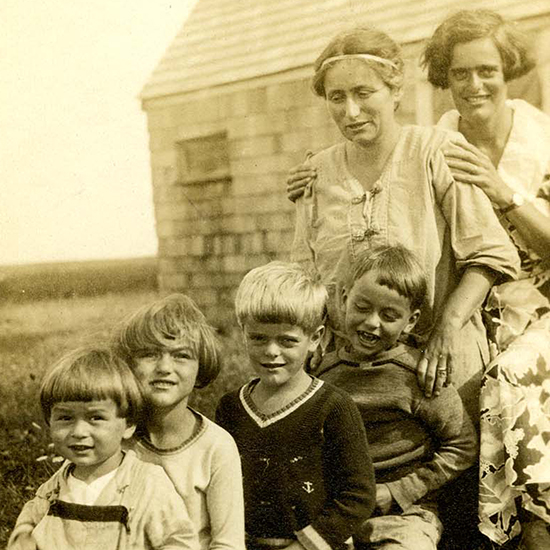 Susan and Elizabeth looking over the four children as all six sit behind each other to pose for the photograph