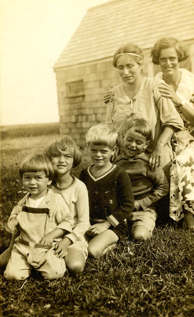Susan and Elizabeth looking over the four children as all six sit behind each other to pose for the photograph