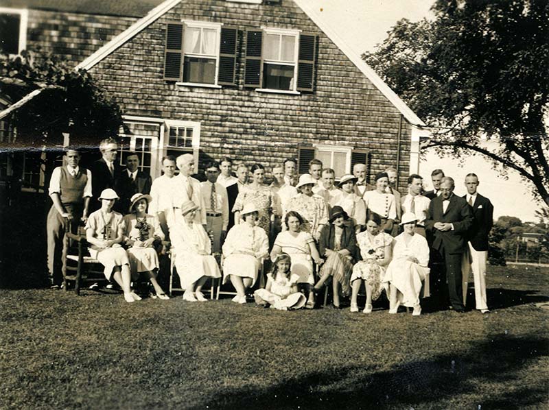 The Brandeis family posing in two rows where the one in the front sits while those in the back stand