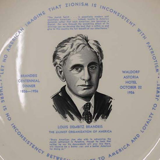 Gold-rimmed decorative plate with an illustration of Louis D. Brandeis (black and white) and his zionism-related quotes