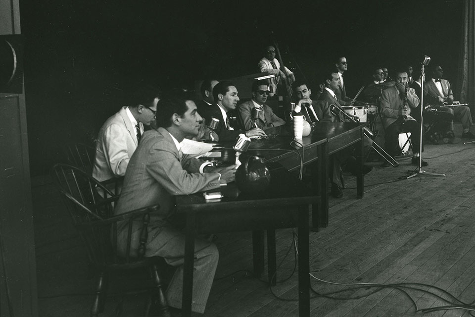 Leonard Bernstein seated with other panelists on the stage at the Jazz Symposium