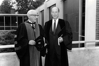  President Sachar & Adlai Stevenson wearing academic robes. The Faculty Club is behind them.