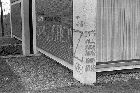 Graffiti on a campus building: "It's All Over Now Baby Blue,"