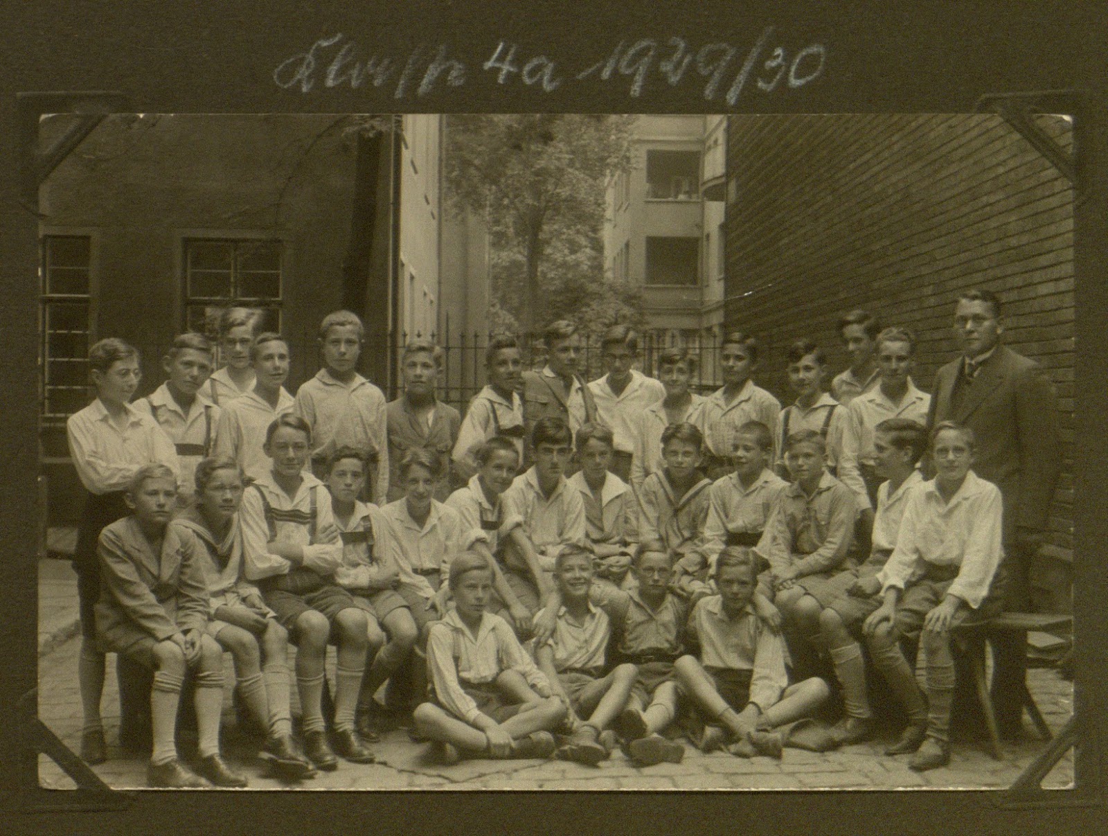Group of boys in uniforms posing for a group photograph