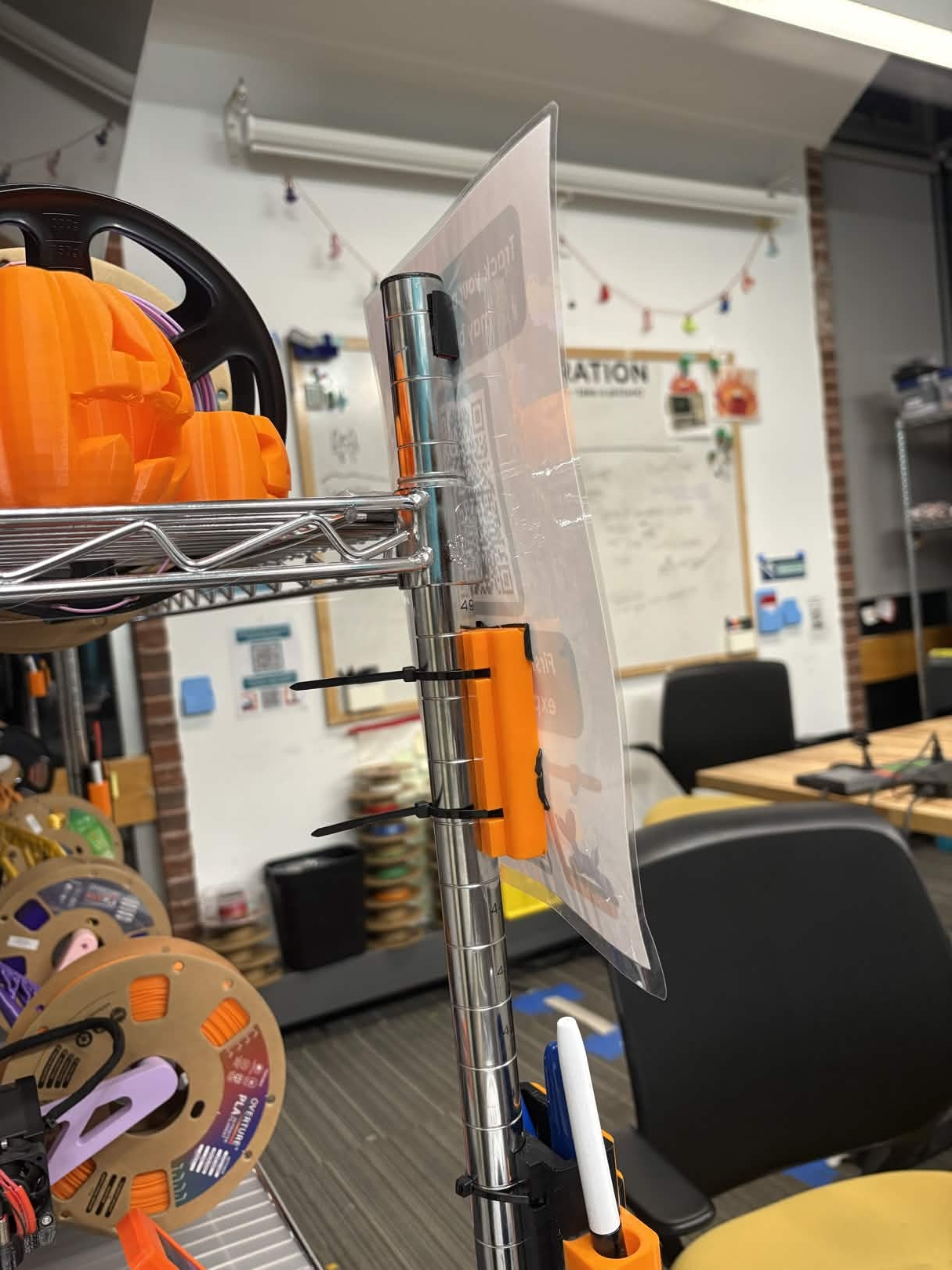 Plastic holder affixed to a wire rack. 