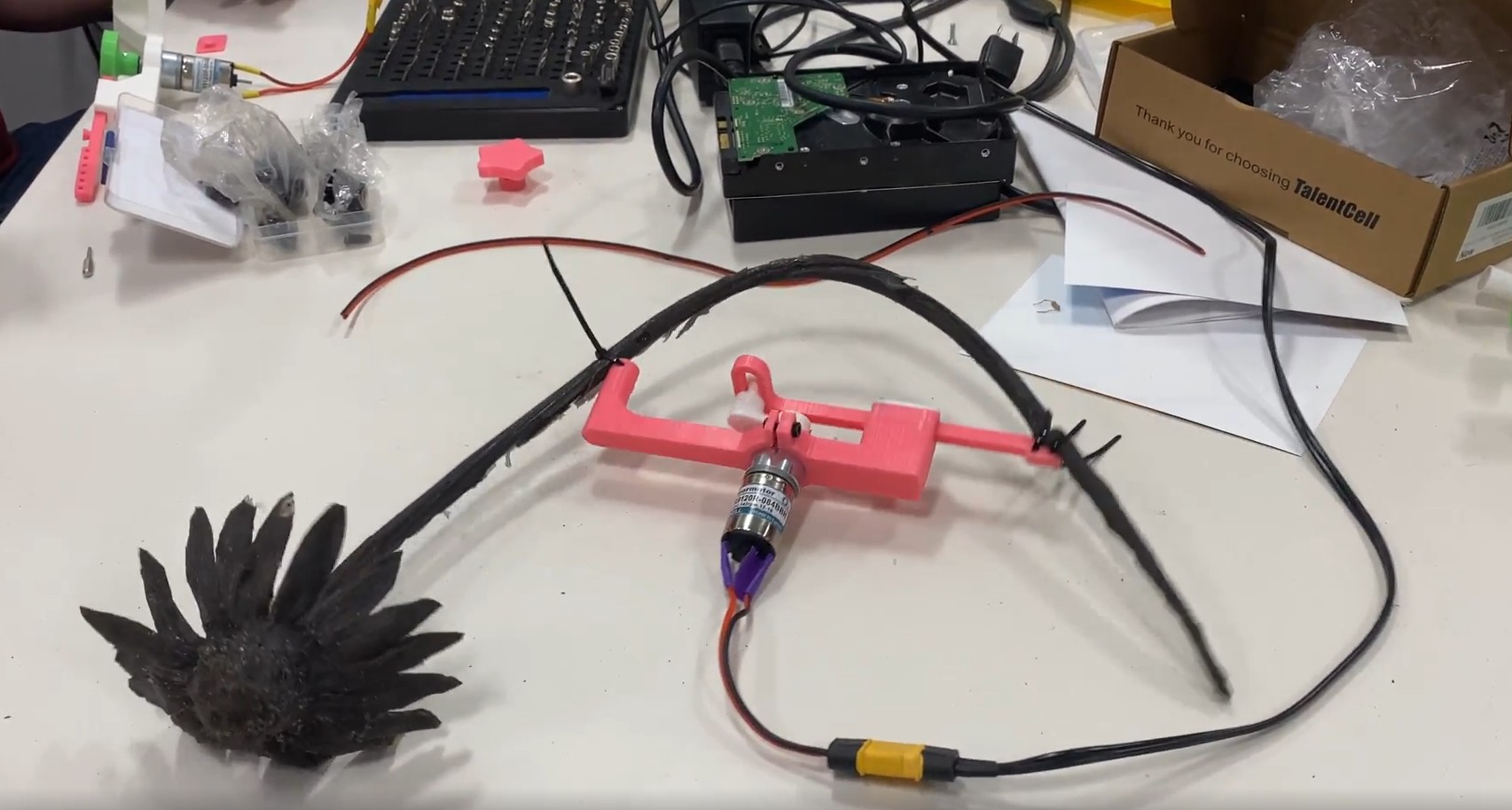 Photo of a mechanical flower on a table. 