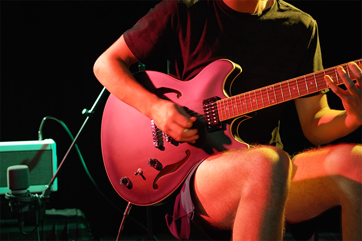 Student playing guitar