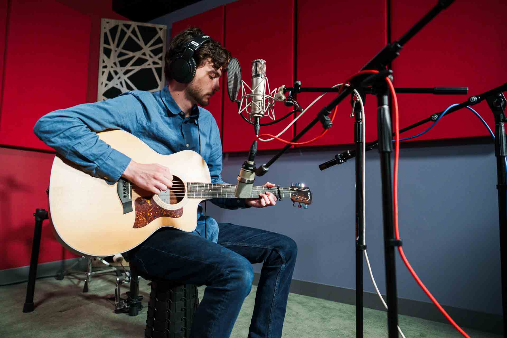 Playing guitar in a recording studio