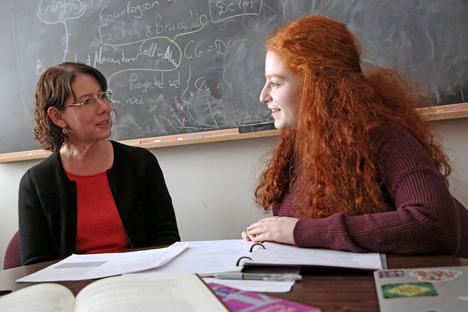 Professor Lotus Goldberg speaks with a student in her office