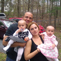 Pedro Fontes ’00 with his wife, Lina, and their twin daughters, Isabel and Emma.