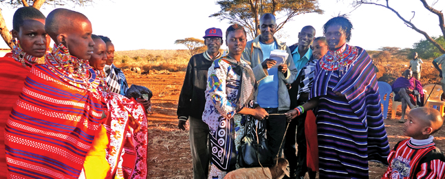 This past summer, after Majiakusi helped to build a new home for her sister Jennifer (wearing purple, standing at right), the village brought sheep and other gifts to mark the occasion.