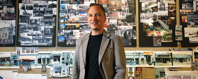 Steve Saklad in front of his design collages for “Labor Day”