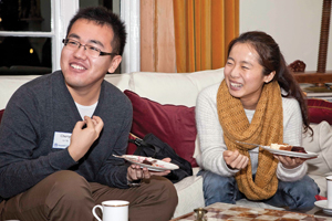 Chenyu Li ’14 and Xinxin Yu ’14 share a laugh with alumni and fellow students at the tea.