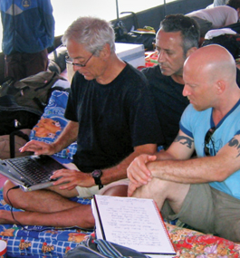 NEWS NOMADS: Bob Simon (left), Michael Gavshon and Solly Granatstein (right) write interview questions onboard a Burmese fishing boat after the 2004 tsunami.