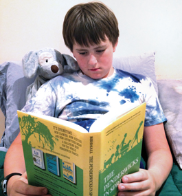 RAPT AT LAST: Kusel's formerly reluctant reader relaxes with a volume from the Penderwicks series.