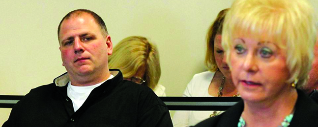 BEFORE THE BOARD: Donovan listens as Carol Hallisey speaks at his May 2014 parole hearing.