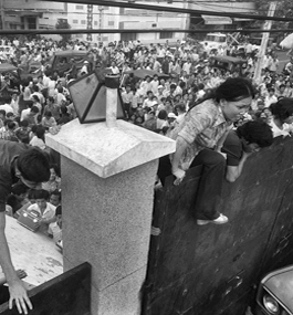 LAST CHANCE: On April 29, 1975, South Vietnamese citizens climb the 14-foot wall around the U.S. embassy in Saigon to try to reach evacuation helicopters.