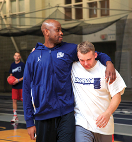 Former teammates Christian Yemga ’11 and Derek Retos ’14 before the men’s basketball alumni game.