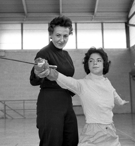 Lisel Judge coaching a student in fencing in 1961