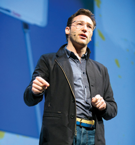 Simon Sinek speaking on stage at an event