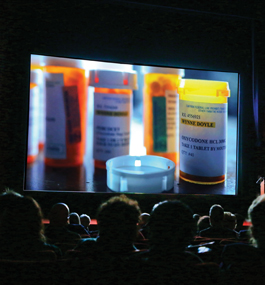 BAD MEDICINE: Audience members at the Opioid Policy Research Collaborative launch event watch the HBO documentary "Warning: This Drug May Kill You."