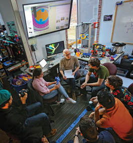 BRAINSTORM: Ian Roy ’05 (top), flanked by Hazal Uzunkaya ’14 and Tim Hebert, with several MakerLab denizens.