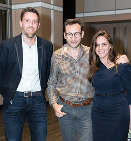 Photo of Simon Sinek and two alums at a Brandeis alumni event.