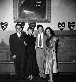 Four smiling undergraduates at a 1951 President's Tea.