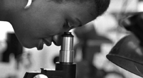 A person looking into a microscope