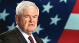 Photo portrait of Newt Gingrich in front of an American flag backdrop