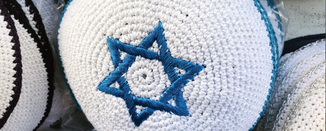 Photo of a kippah with a blue Star of David embroidered on the top