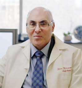 Head shot of a man wearing a lab coat.