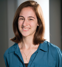 Head shot of a smiling woman wearing a blue shirt.