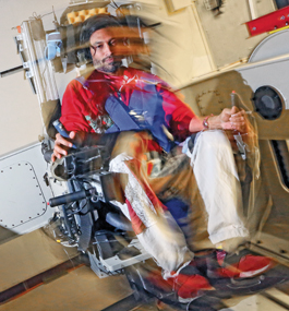 Research scientist Vivekanand Vimal, GSAS PhD’17, demonstrates the movement of the Multi-Axis Rotation System chair, which tests people’s balancing skills and spatial orientation.