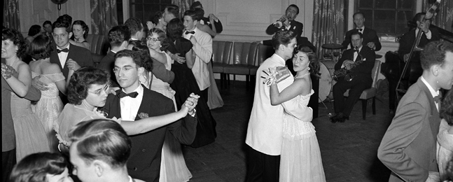 A 1949 photo of young people dressed in formal eveningwear dancing