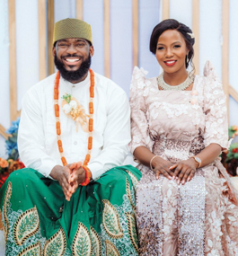 Photo of a smiling man and woman in finely decorated attire