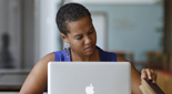 Photo of a young woman working at a laptop