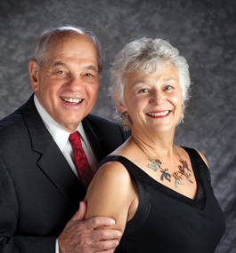 Photo of a smiling gray-haired man and woman