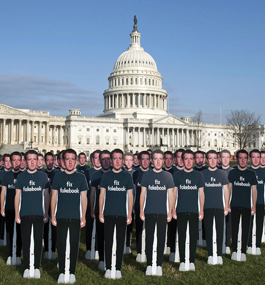Dozens of cutouts with Mark Zuckerberg's face and body stand on the U.S. Capitol lawn; each is wearing a T-shirt that says "Fix Facebook."